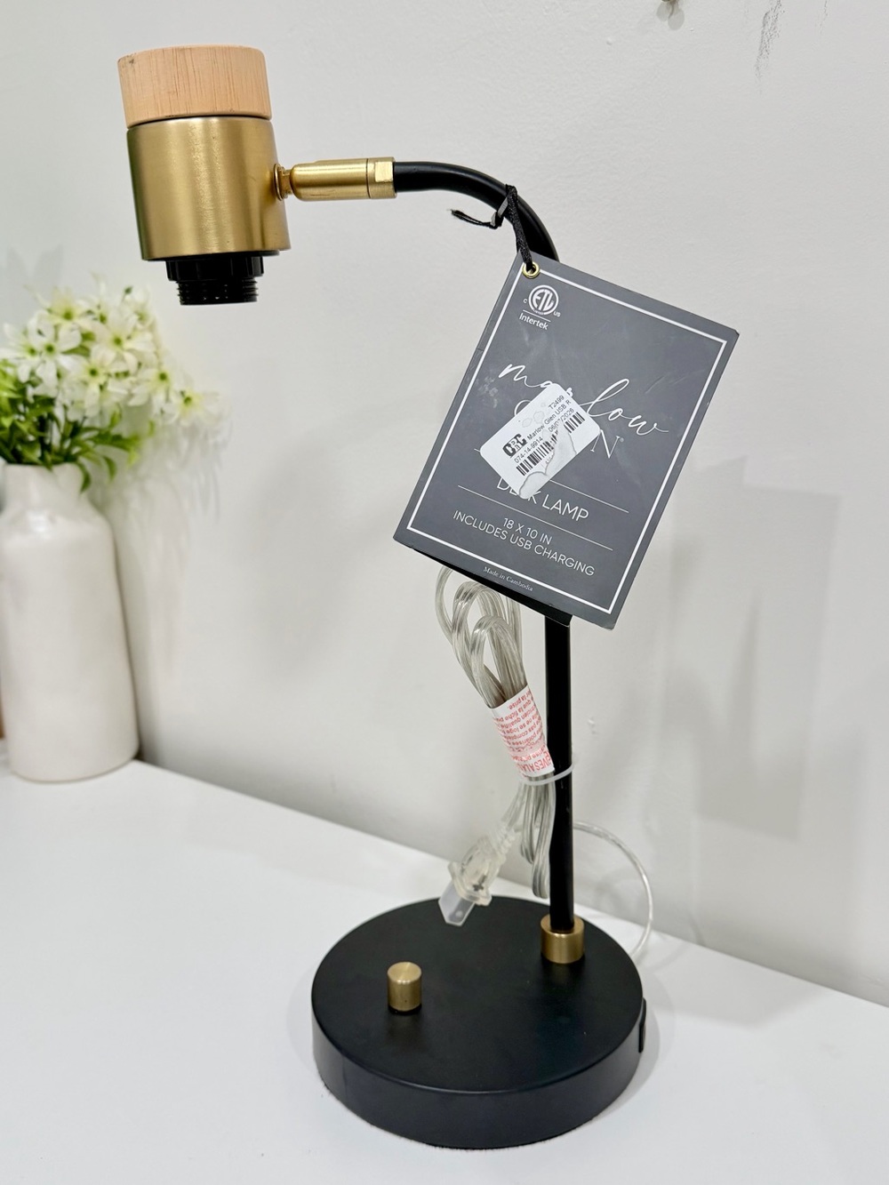 black and brass desk lamp with a small wooden accent piece on the socket